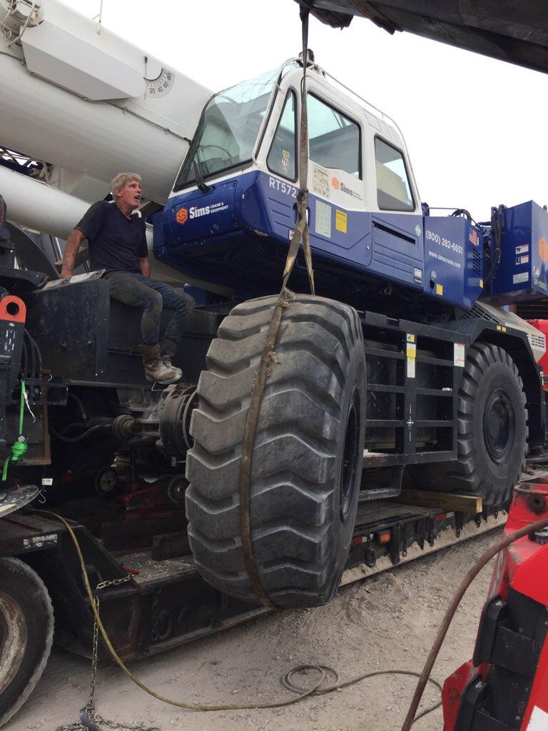 Export Logistics & Shipping, Inc. in house crane crew removes Tadano GR1000XL-5 crane tire